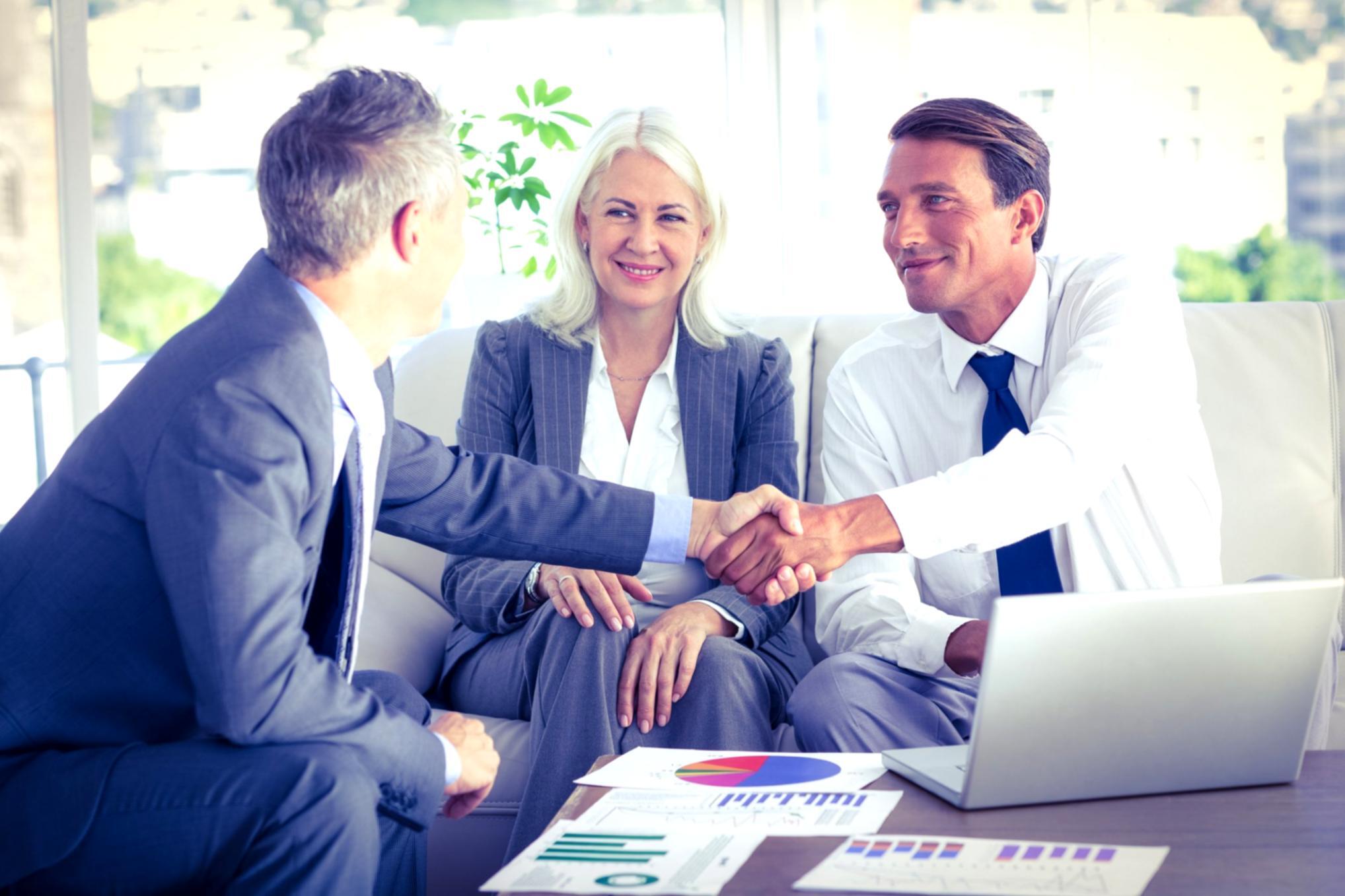Family business owners collaborating on financial planning documents during program session